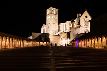 Assisi Basilica by night,  Umbria region, Italy. The town is famous for the most important Italian...