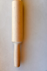 Wooden rolling pin for dough on a white background