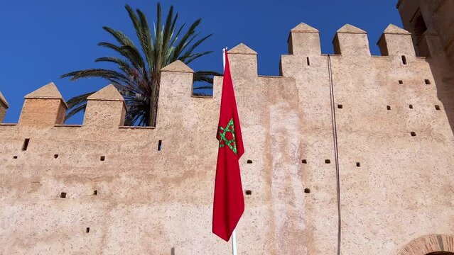 Moroccan flag with old ruined fortified wall in Rabat
