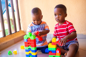 young boys playing creative toy blocks for homeschooling