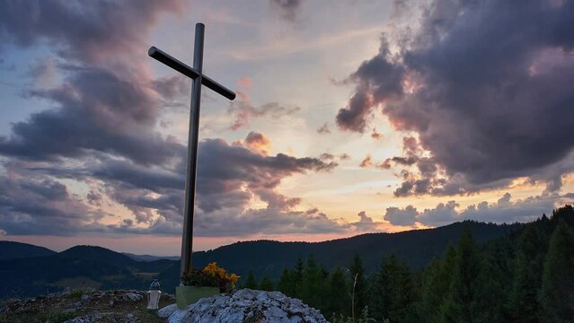 Christian cross on a mount top at the sunset, religious time lapse scene, 4K