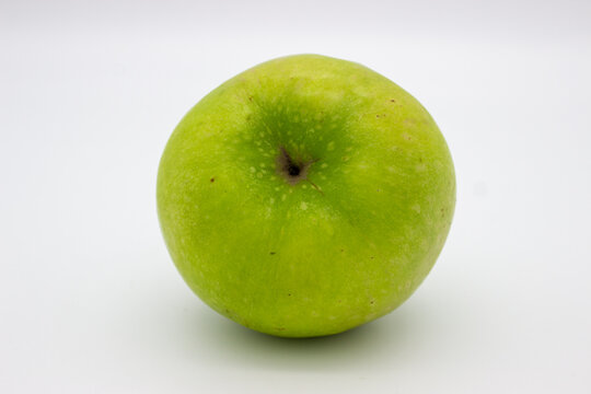 One green apple on white background