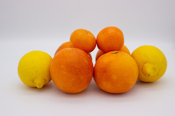 Few oranges, tangerines and lemons on white background.