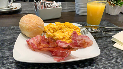 Typical English breakfast, bread, scrambled eggs and becon.