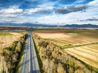 Aerial drone view of the highway between country areas, Tuscany, Italy