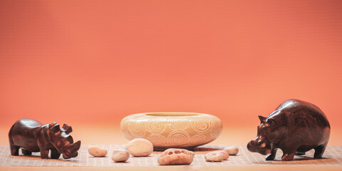 Clay vase and wooden figurines with the stones