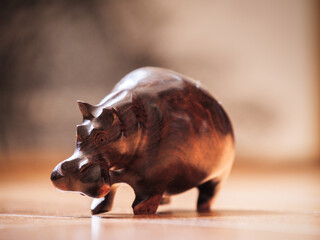 Handmade wooden hippo figurine in the sunlight