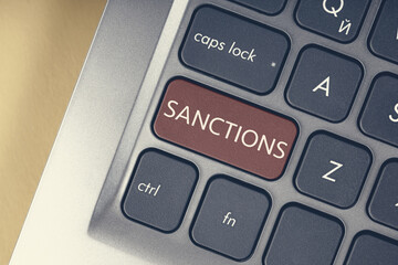 Close-up of the red button with the text of the sanction on the conceptual keyboard.
