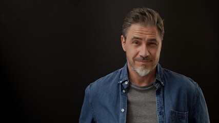 Portrait of mature age, middle age, mid adult man in 50s, happy confident smile. Copyspace.