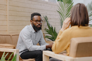 a male psychologist conducts a patient's appointment in an office or a medical center. African...