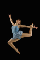 girl-dancer in a jump on a black background