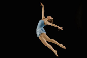 girl-dancer in a jump on a black background