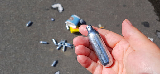 Nitrous oxide patrons used for laughing gas as a drug in Denmark and dumped in the streets - obrazy, fototapety, plakaty