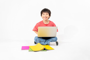 Portrait of Happy asian boy on floor with laptop and books isolated on white background, Education and learning with technology concept