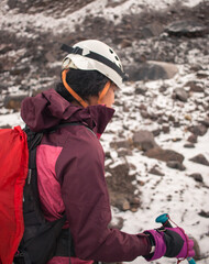 Fototapeta na wymiar Closeup portrait of dark beautiful young woman in mountaineering gear hiking 