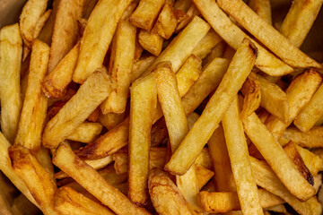Crispy French fries background closes up image.