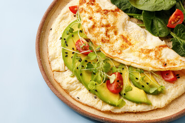 Avocado Omelet with spinach salad close up. Vegetarian breakfast. Omelette