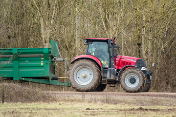 Case Puma 340 red tractor towing a Samson Flex-16 green muck spreader