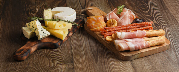 Appetizers table with antipasti snacks. Cheese and meat variety board. Top view