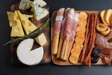 Mixed delicatessen with charcuterie and cheese board with a place for text.  Space for banner,...
