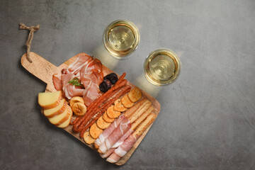 White wine with charcuterie assortment on the background. Copy space