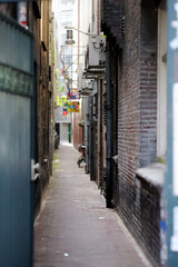 Narrow street between two houses in Amsterdam, Netherlands.