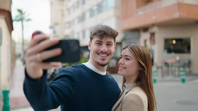 Young couple smiling confident making selfie by the smartphone at street