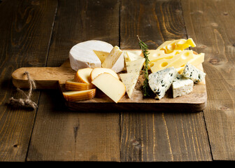 Various kind of fresh cheese on board. Set of different cheeses. Copy space