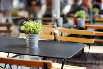 Empty restaurant table decorated with flowers in a typical Amsterdam street, Netherlands