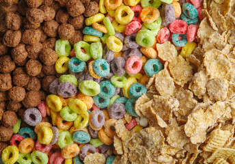 Assorted whole grain quick, ready to eat breakfast cereals, fruit rings and chocolate balls. Close-up. Supermarket, sales, advertising business, banner.