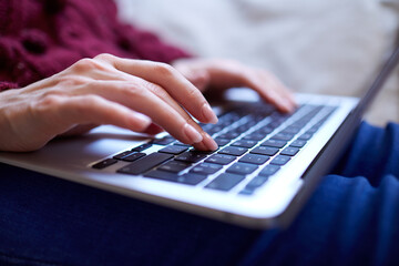 Beautiful woman relaxing at home with notebook