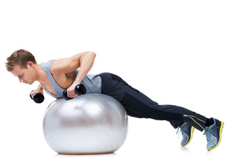 Really working those arms. Shot of a man balancing on an exercise ball lifting weights.
