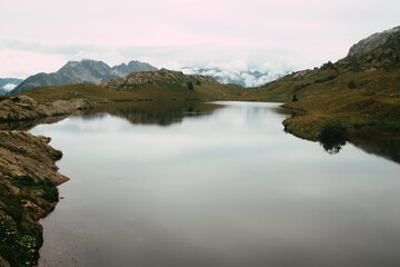 High altitude lake and mountain ranges in a cold and austere atmosphere