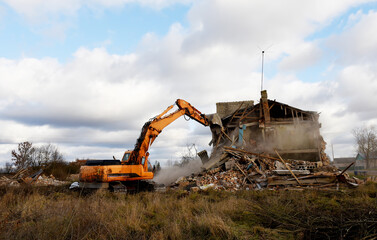Excavator during demolition the house in the rural. Renovation old home and construction project....