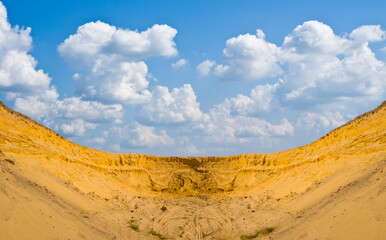 sandy desert under cumulus cloudy sky