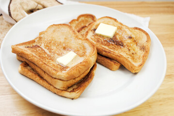 Fried French Toast served on a Plate with Butter	