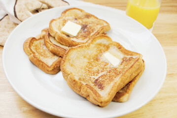 Fried French Toast served on a Plate with Butter	