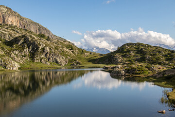 Fototapeta premium High altitude lake at the foot of the mountains and mountain ranges in the French Alpes