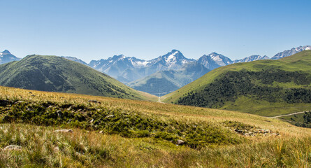 Fototapeta na wymiar Two mountains separated by a road or path in French Alpes - Alpes d'Huez