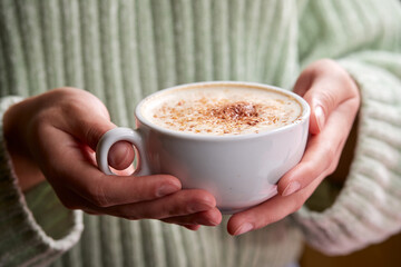 woman with cup of cappuccino