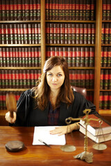 Shes an expert in the legal world. Shot of a young legal professional sitting at her desk in a study.