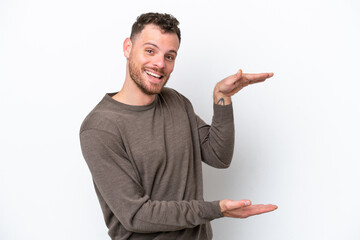 Young Brazilian man isolated on white background holding copyspace to insert an ad