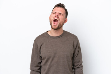 Young Brazilian man isolated on white background shouting to the front with mouth wide open