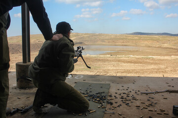 A soldier fires a machine gun israel . High quality photo