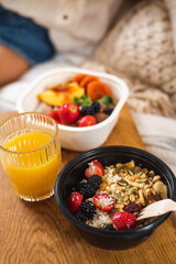 Granola for breakfast. Healthy Eating. Porridge with fruit and seeds and orange juice. A pleasant morning. Oatmeal in a bowl