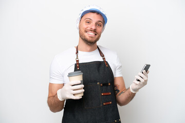 Fishmonger man wearing an apron isolated on white background holding coffee to take away and a mobile