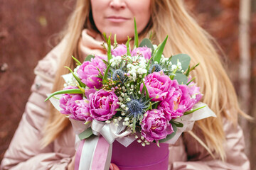 Beautiful bouquet of purple tulips in a box. Gift to a woman on International Women's Day. March 8 gift for women