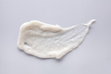 Cosmetic balm, lip balm or peeling gel smudge texture gray isolated background