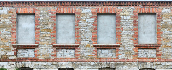 Old rustic house wall, with bricked up window.