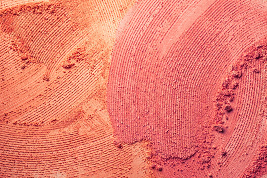 Blusher or pressed powder orange coral red make-up textured background